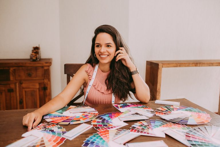 Woman with long hair comparing color swatches to find the perfect hair extension shade