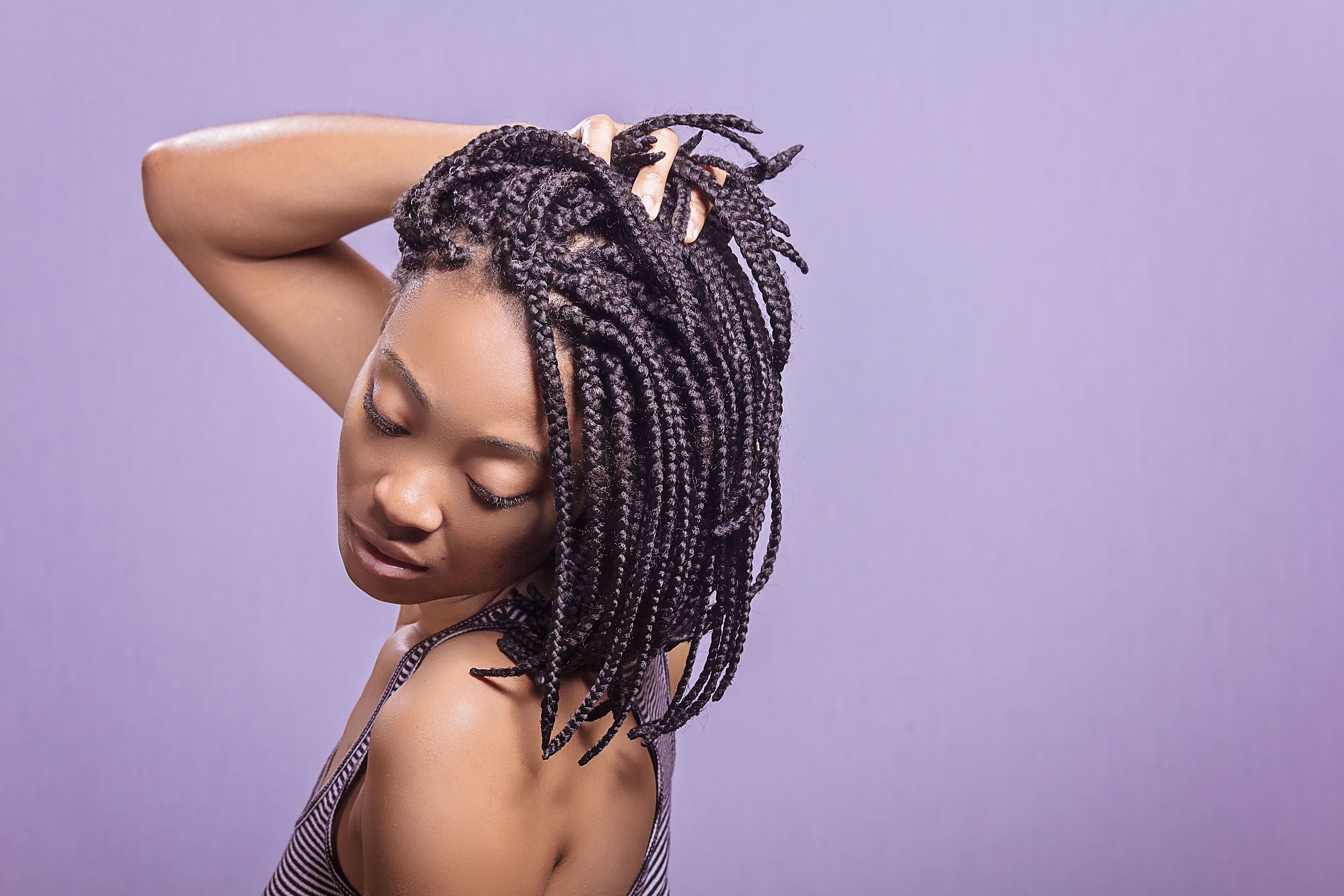 Portrait of a woman with a braided hairstyle showcasing natural-looking textured extensions